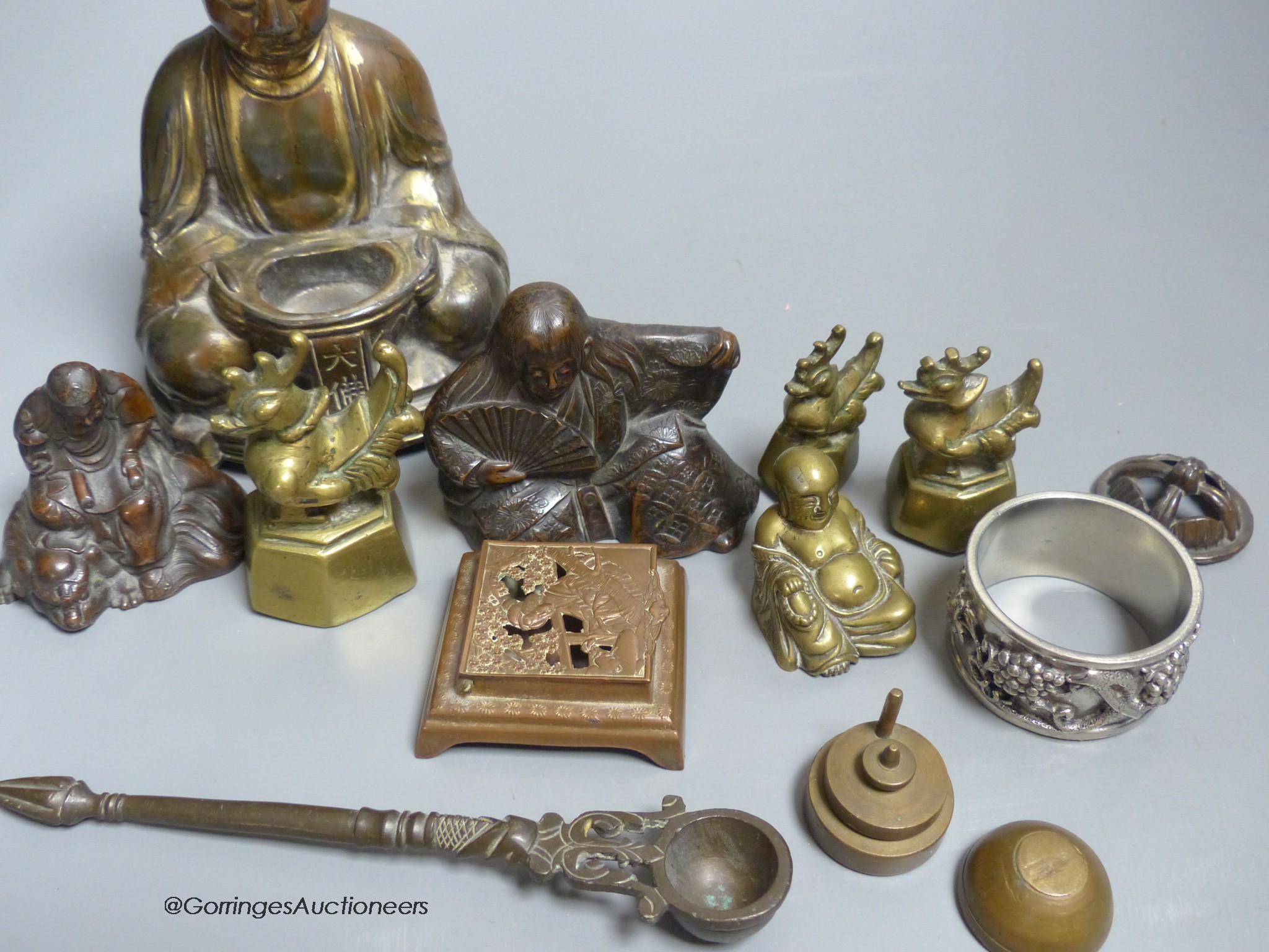 A group of mixed Oriental Buddha's, vases, weights, etc.